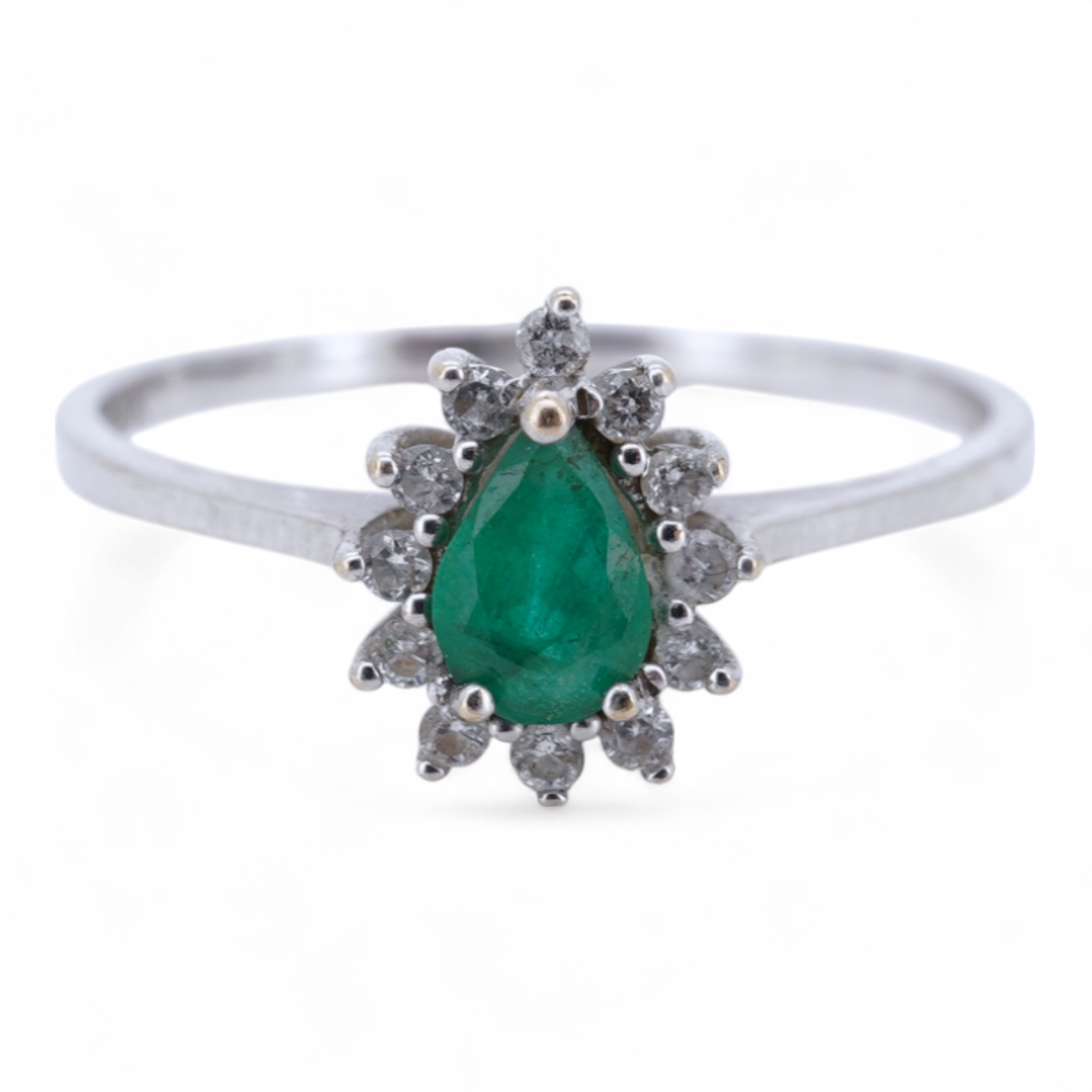 A modern white metal(stamped 14k), emerald and diamond set pear shaped cluster ring, size R, gross weight 1.3 grams.